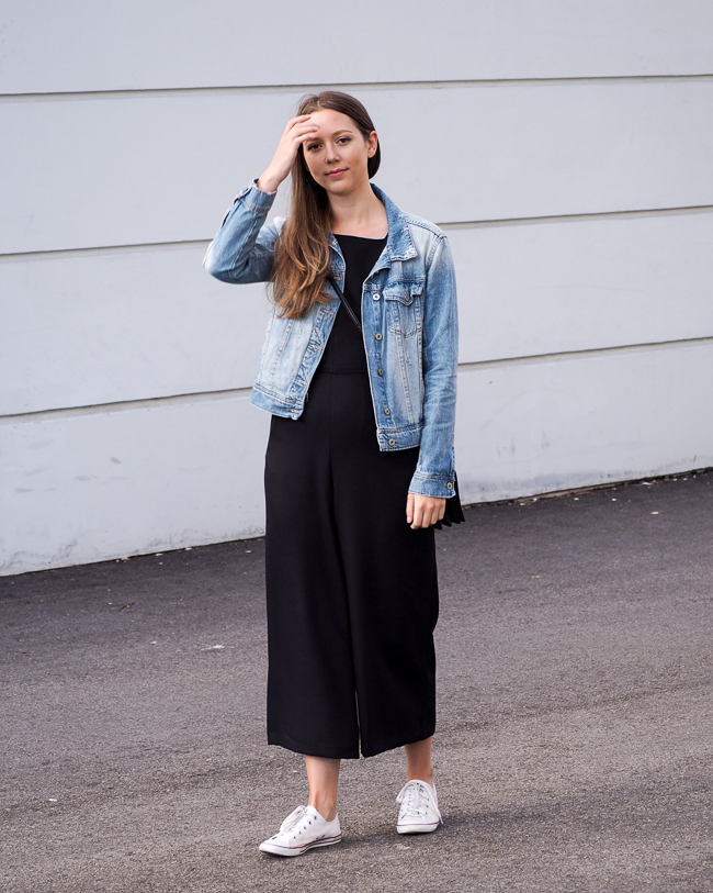 Premium Photo | Portrait of a beautiful american girl in a black jumpsuit  and a white jacket with colorful bags