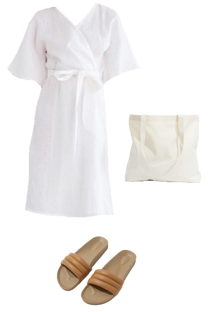 Summer capsule wardrobe outfit ideas - white linen wrap dress, canvas tote bag, tan sandalias